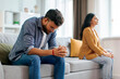 © Home-stock - Crisis in relations. Indian man and woman offending to each other after argue, grumpy spouses sitting on couch, feeling angry and upset