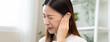 © Pormezz - ear problem concept, Young woman touching her ear feel pain from inflammation.