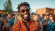 © Larisa AI - A cheerful man wearing sunglasses and a bright orange shirt smiles widely at a lively outdoor gathering, portraying joy, community, and the spirit of celebration.