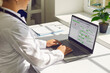 © Studio Romantic - Doctor in office using laptop calendar schedule. Healthcare professional manages online bookings, plans visits, types notes at desk. Medical scheduling and telehealth productivity concept.