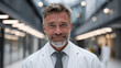 © Keopaserth - Confident middle aged male executive in white lab coat smiling in modern biotech facility, professional portrait conveying trust and leadership
