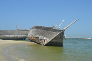 Naklejka na meble An old, broken boat looks out to sea. Hope slowly dies with it. Foggy future. 