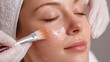 © Olga Ко - Closeup of relaxed woman face during chemical peeling procedure applied by therapist hands, Skin care and SPA concept.