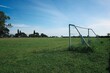 © onehourhappiness - Empty Soccer Field with Goal and Blue Sky, Outdoor Sports Grass Pitch