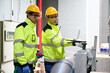 © offsuperphoto - Engineers collaborate and inspecting equipment in the factory