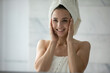 © fizkes - So clean and fresh. Excited beautiful young lady wrapped in towels after refreshing bath procedures touch face with palms admire perfect condition of soft moisturized radiant skin in mirror reflection