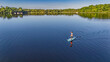 © Iuliia Sokolovska - Active woman paddling SUP board on beautiful Lough Key lake, green islands and forest summer landscape on background, stand up paddling water adventure outdoors, Ireland