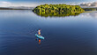 © Iuliia Sokolovska - Active woman paddling SUP board on beautiful Lough Key lake, green islands and forest summer landscape on background, stand up paddling water adventure outdoors, Ireland