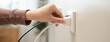 © Pormezz - Close-up hands pull off electronic device plug after finish used.
