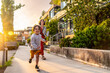 © unai - Happy child running in vancouver with mother at sunset