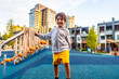 © unai - Happy child playing in a modern city playground in vancouver