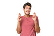 © luismolinero - Young handsome caucasian man over isolated background with fingers crossing