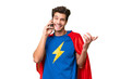 © luismolinero - Super Hero caucasian man over isolated background keeping a conversation with the mobile phone with someone