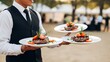 © Hayyat - Professional waiter meticulously serving three plates of gourmet steak dishes at an elegant outdoor catering event, highlighting exceptional hospitality and fine dining experience