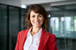 © Stock 4 You - Headshot corporate portrait of successful mature latina european woman 40s 50s, business leader, confident manager, beautiful ceo in red jacket smiling in modern office workspace, looking at camera