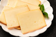 © Alesia Berlezova - Raclette cheese portion slicing natural product tasty snack fresh delicious gourmet food background on the table rustic top view copy space