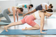 © JackF - Group of young women in sportswear doing pilates exercises in studio