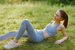 © SHOTPRIME STUDIO - Young woman in workout attire enjoying a sunny day outdoors, showcasing a healthy lifestyle and joyous emotions in a vibrant green setting