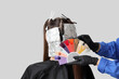 © Pixel-Shot - Female hairdresser's hands with color palette dyeing hair of client on light background, back view
