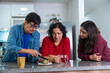© FABIAN PONCE GARCIA - Latino family cutting a lemon to prepare tea