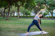 © leungchopan - Woman enjoy yoga time at green park