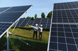 © Serhii - Engineers discussing solar energy field with panels