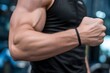 © Adnan - muscular male arm closeup and strength concept at gym