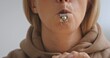 © kinomaster - Close Up of Woman Blowing Silver Whistle