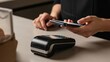 © Tanakorn - Hands perform swift mobile contactless payment with smartphone over a modern POS terminal, embodying digital transaction convenience for shoppers