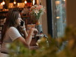 © sittinan - woman relax in cafe and use smartphone