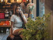 © sittinan - woman relax in cafe and use smartphone