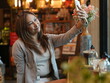 © sittinan - woman relax in cafe and use smartphone
