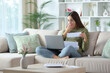 © PheelingsMedia - Amazed woman doing online accounting checking laptop