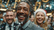 © scaliger - Happy people celebrating New Year and christmas at festive corporate party with confetti and holiday cheer, black man in foreground