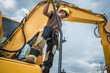 © Tomasz Zajda - Worker Operates Heavy Machinery Near Power Lines