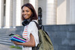© Pawel - Portrait of a young college girl holding folders and notebooks and walking down the street to go to school or college. Student girl smiling and happy