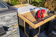 © Tomasz Zajda - Construction Work on a Flat Roof Structure Near Trees