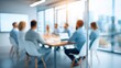 © Alina - Professionals engaged in a business meeting in a modern office