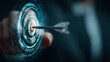 © john - Businessman holding a futuristic glowing target with an arrow hitting the bullseye representing success and achievement in the year 2026