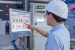 © reewungjunerr - Electrical engineer male checking voltage at the Power Distribution Cabinet in the control room,preventive maintenance Yearly,inspecting power system and control panel in industrial factory