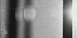 © Nasrin - A grayscale close up reveals a textured abstract surface with subtle tonal variations and linear markings