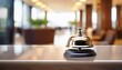 © Jacob - elegant reception bell on a polished surface with the blurred background showing a hotel lobby area a symbol of service waiting for the next guest