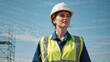 © Vasiliy - Confident female engineer wearing a hard hat and safety vest at a construction site. Professional woman worker looking up with a determined expression