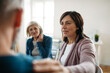 © Halfpoint - Sharing painful experiences during guided therapeutic session. Empathetic shoulder touch.