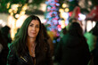 © FotoAndalucia - Informal Portrait of a Woman Looking at Christmas Lights in a European City on a Winter Night