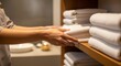 © Zhanna - Hotel Staff Stacking Fresh Towels on Shelf in Bathroom
