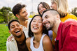 © Xavier Lorenzo - Multiracial group of young friends having fun together outdoors in summer. Millennial student people laughing walking in city street enjoying day off. Youth community and friendship concept.