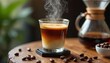 © miss irine - Steaming cup of Vietnamese coffee layered with condensed milk and dark brew. Coffee beans scattered on rustic wood table, Chemex brewer in background. Enjoy a hot drink.