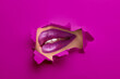 © New Africa - Woman with beautiful plump lips, view through torn hole in purple paper