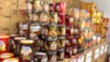 © arok - Defocused background of a shelf of Eid biscuit tins in a supermarket. Abstract and blurred background